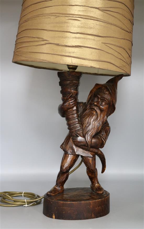 A carved wood dwarf table lamp